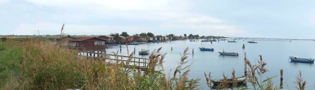 fishing houses along a fishing basin, po river delta, italy