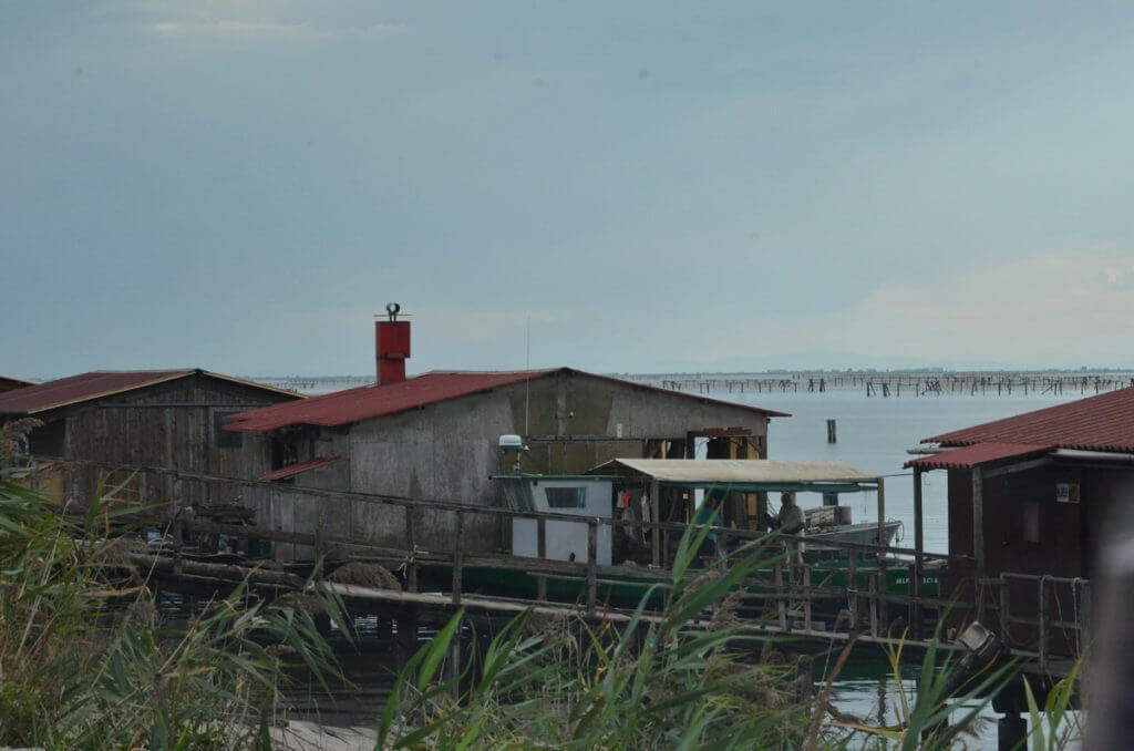 fishing houses on a lagoon, parco regionale veneto del delta del po, po river delta, italy 