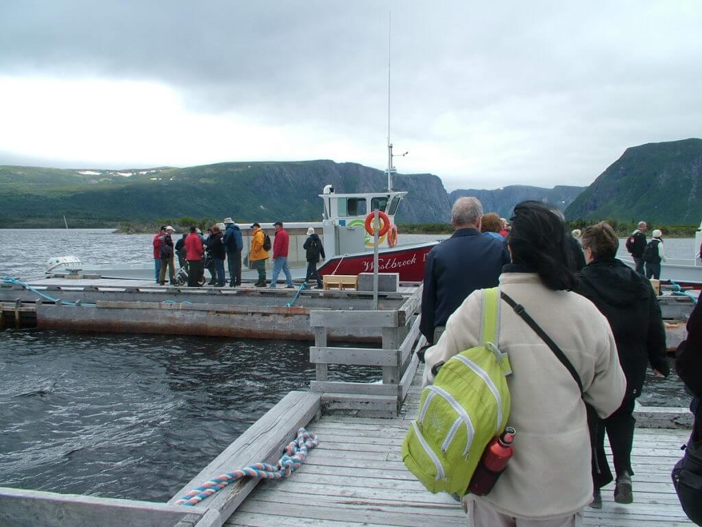 passengers boarding a tour boat, western brook pond, gros morne national park, newfoundland, canada