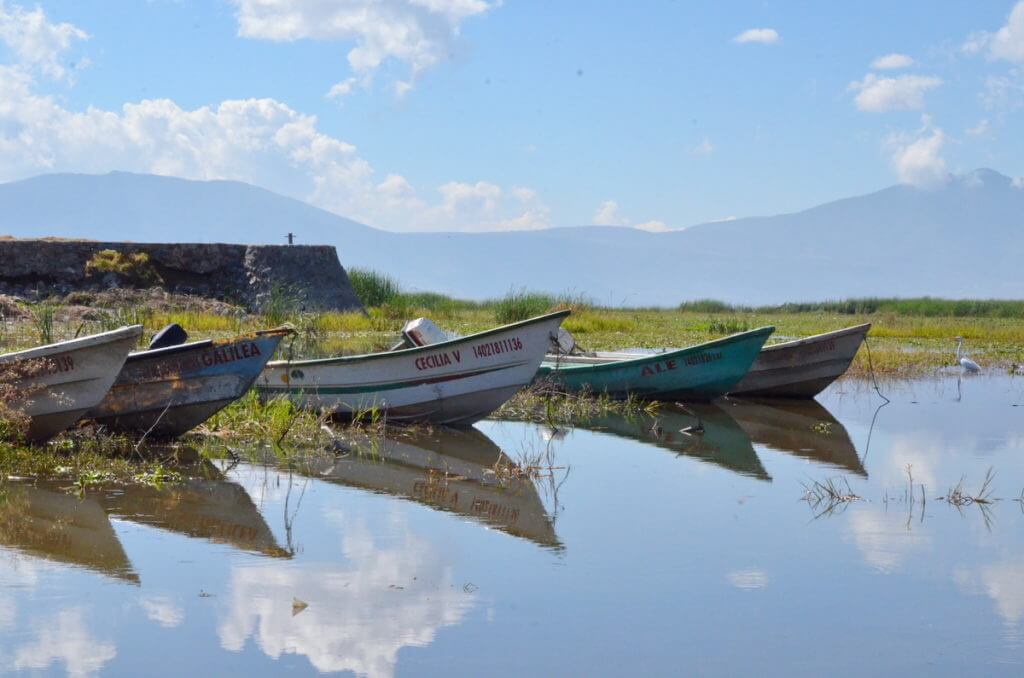 motorboats reflected in lake chapala, mexico
