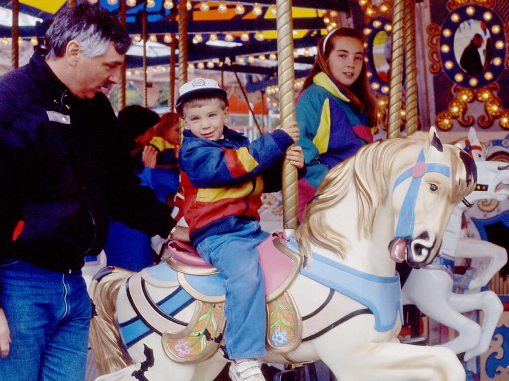 bob with his kids on the merry-go-round, markham fair, 1991