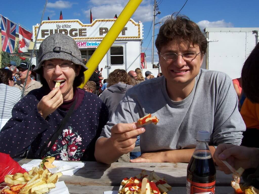 people eating fries, markham fair, markham, ontario, 2007
