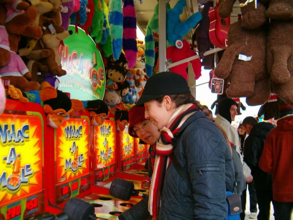 people playing whac-a-mole, markham fair, markham, ontario, 2010