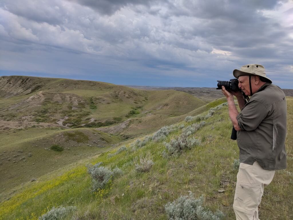 Image of bob taking a picture at borderlands lookout, grasslands national park, saskatchewan