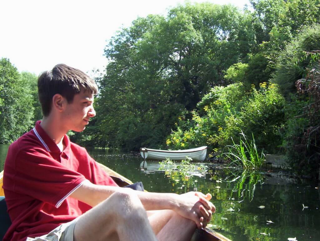 a person in a punt, avon river, bath, england