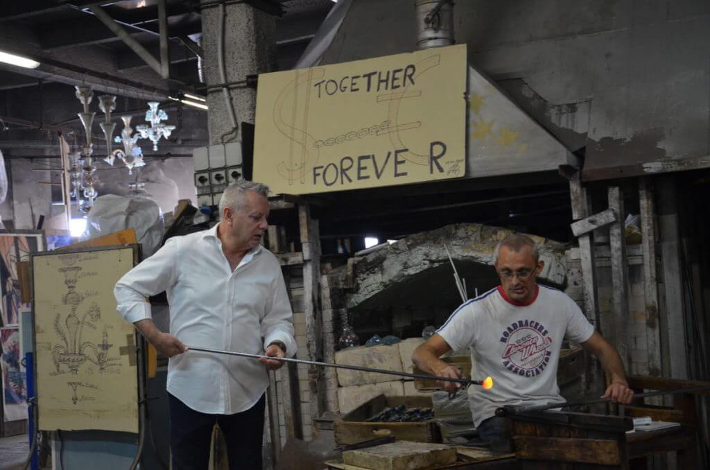 artisans working with molten glass, gino mazzuccato glass factory, murano island, venice, italy