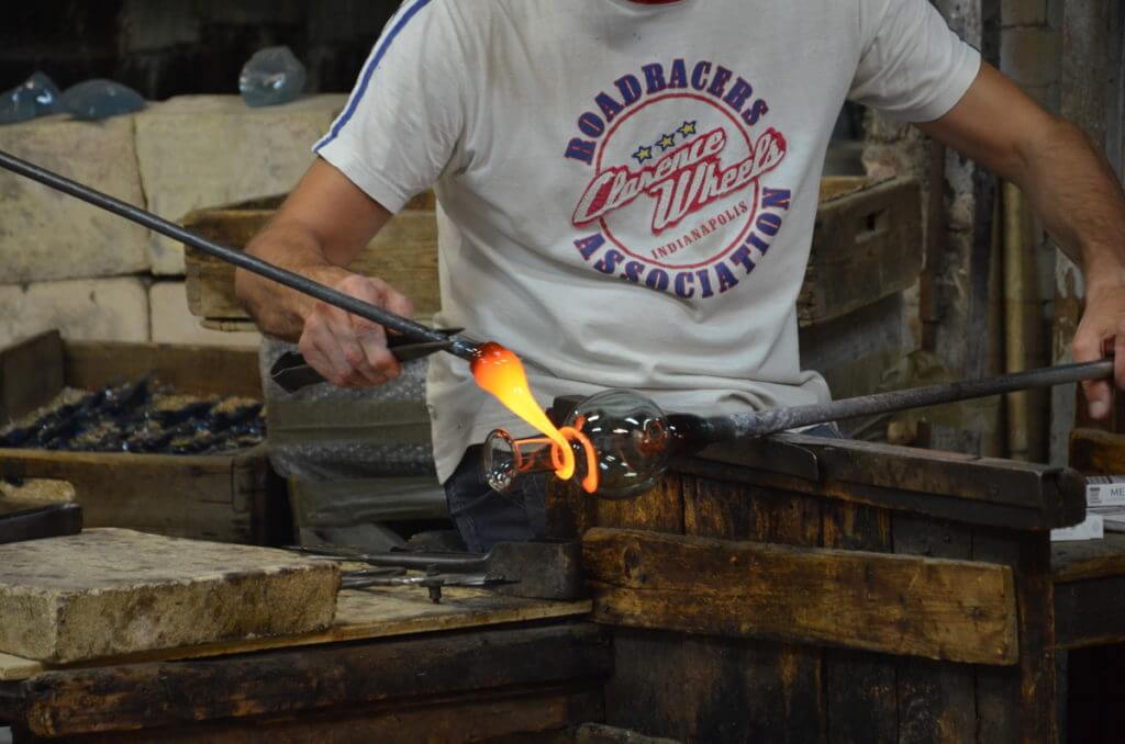 an artisan using large tweezers, gino mazzuccato glass factory, murano island, venice, italy