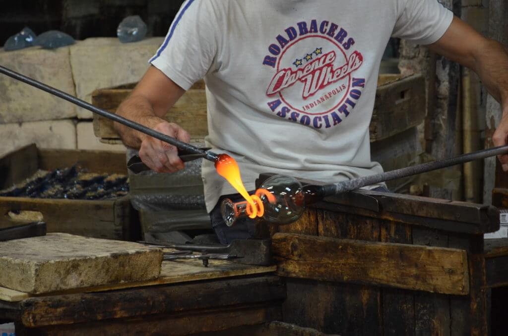 an artisan using large tweezers, gino mazzuccato glass factory, murano island, venice, italy