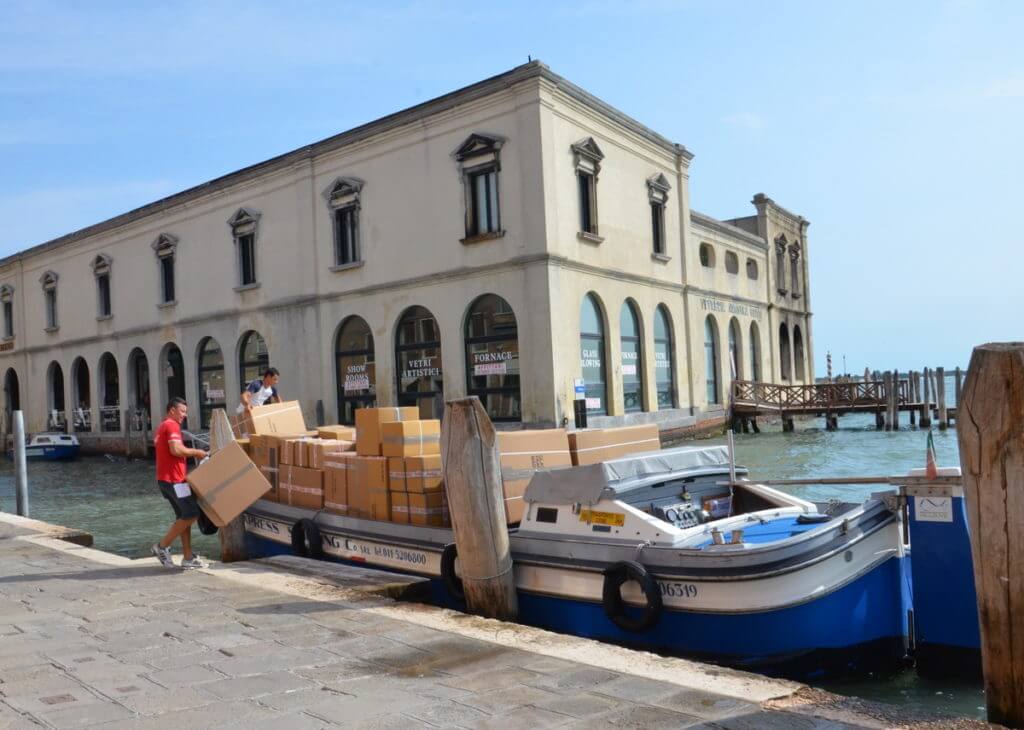 murano glass being loaded on a boat, murano island, venice, italy