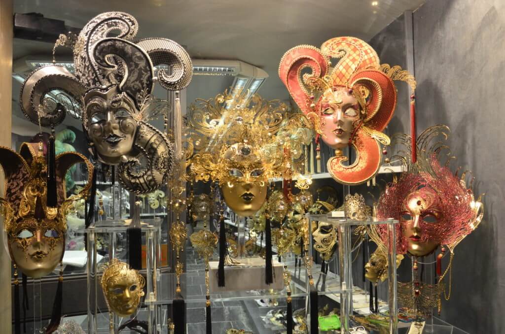 festive masks in a shop window, venice, italy