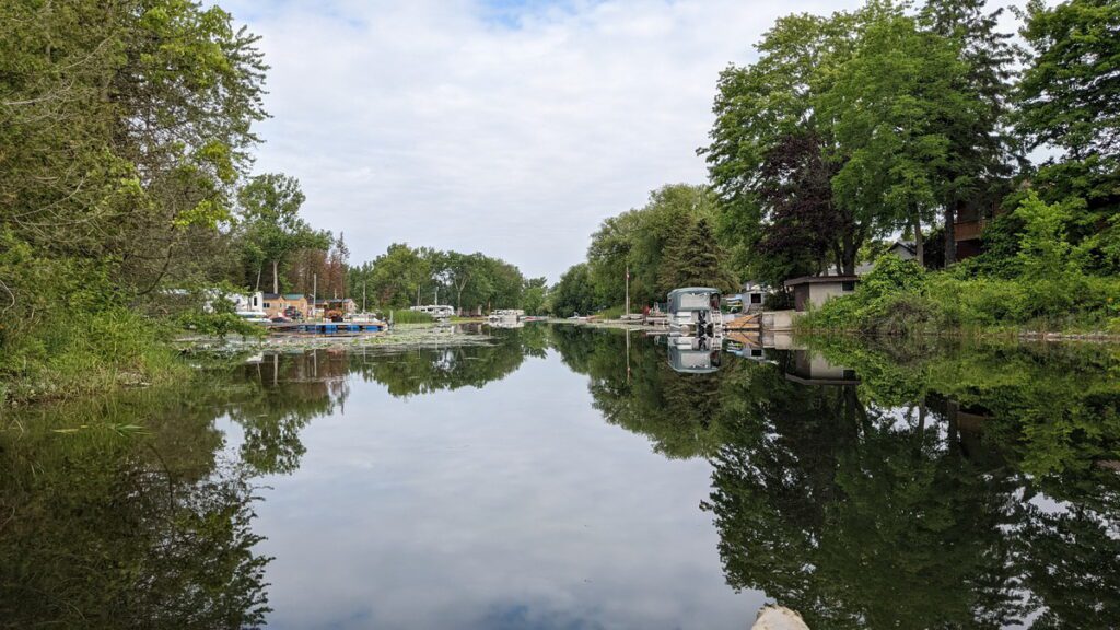 image of calm water on the outlet river in sandbanks provincial park, ontario