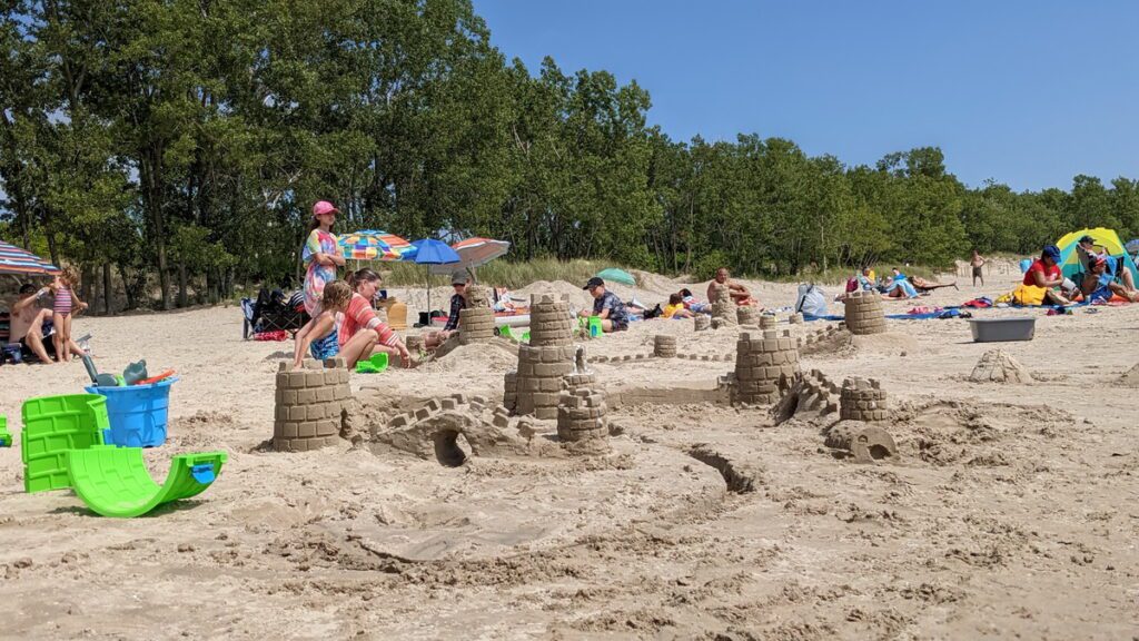 image of children making sand castles at sandbanks provincial park, ontario