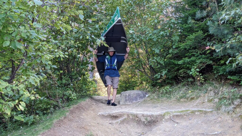 Image of Bob portaging our canoe in Algonquin Park.