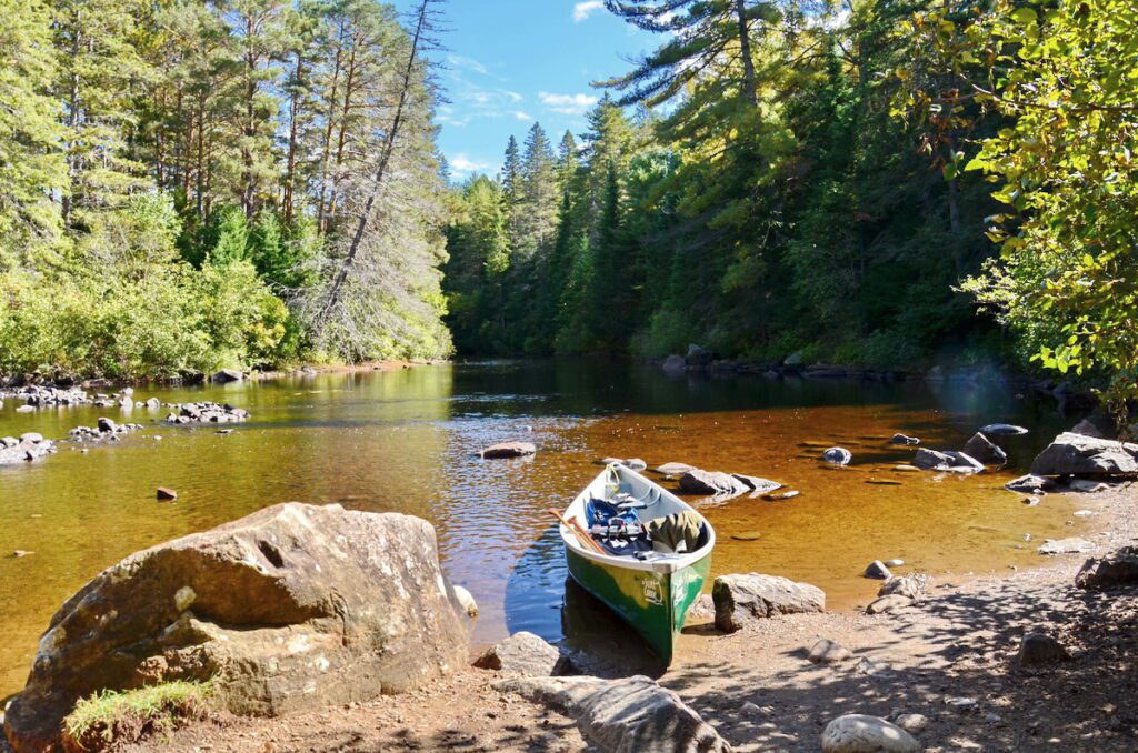 Image of canoe sitting on the river edge in Algonquin Park.