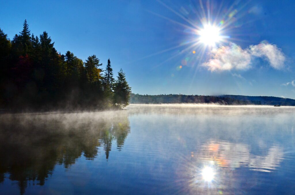 Image of early morning mist and fog over Smoke Lake in Algonquin Provincial Park in Ontario, Canada.