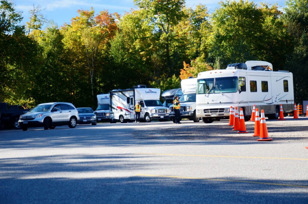 Image of cars and trucks at the west gate entrance gate in Algonquin Provincial Park in Ontario, Canada.