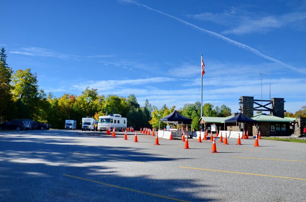 Image of cars and trucks at the west gate entrance gate in Algonquin Provincial Park in Ontario, Canada.