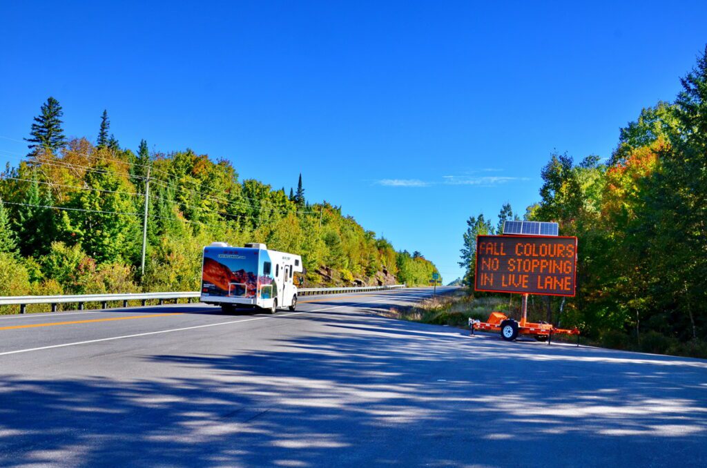 Image of the fall colors no stopping sign along highway 60 in Algonquin Provincial Park in Ontario, Canada.
