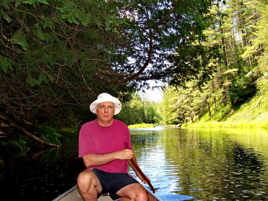 Image of Bob canoeing on the Barron River in Algonquin Park, Ontario, Canada. A popular canoeing route..