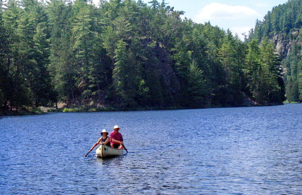 Image of Bob and Jean canoeing the Barron Canyon in Algonquin Park, Ontario, Canada. A popular canoeing route..