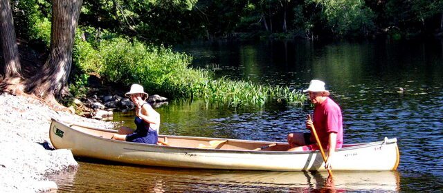 Image of Jean and Bob canoeing on the Barron River, Algonquin Park, Ontario, Canada.