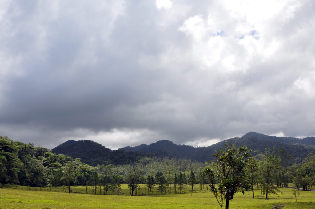 image of dark clouds over pastureland, arenal observatory, costa rica