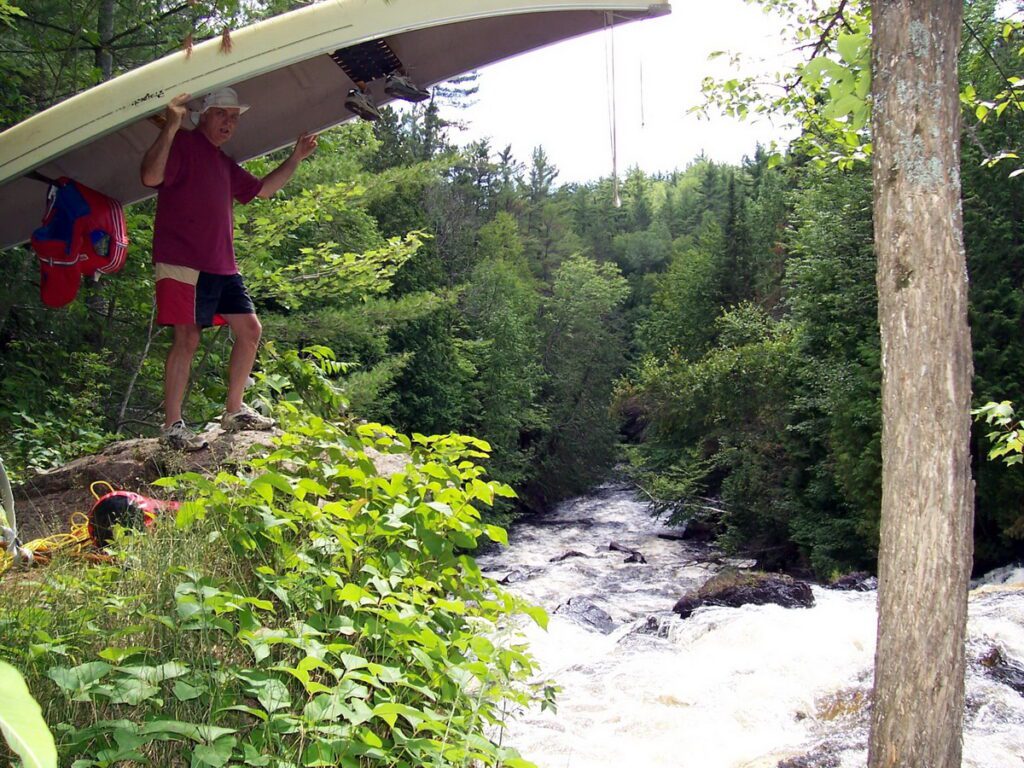Image of Bob portaging a canyon along the Barron Canyon in Algonquin Park, Ontario, Canada. A popular canoeing route..