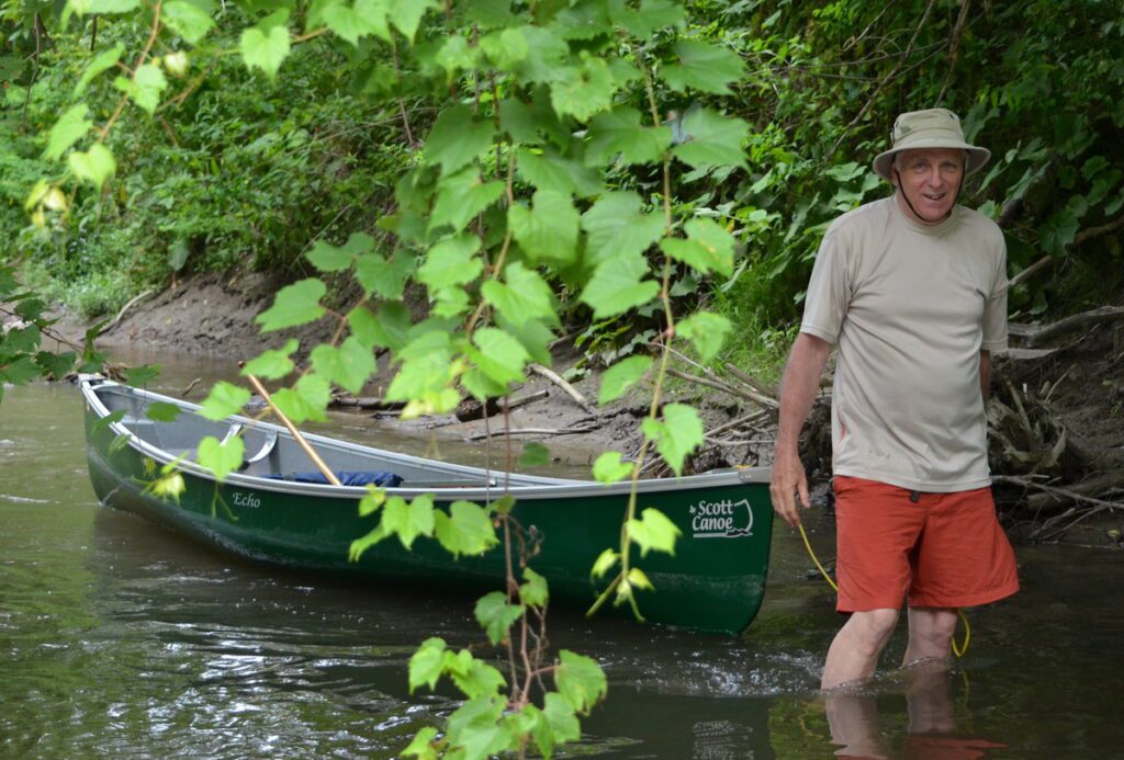 Image of Bob portaging up Duffins Creek in Ajax, Ontario, Canada.