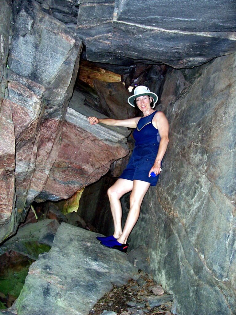 Image of Jean standing in a cave along Barron Canyon in Algonquin Park, Ontario, Canada. A popular canoeing route..