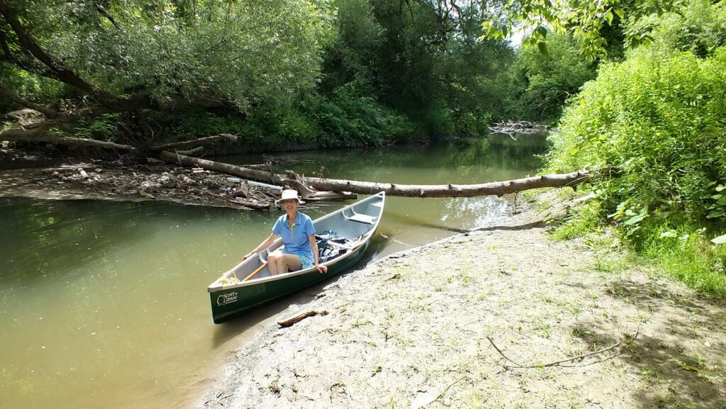 Image of Jean sitting in our canoe on Duffins Creek in Ajax, Ontario, Canada.