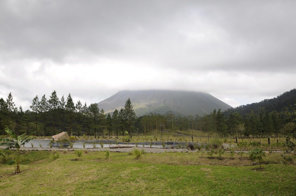 image of a water hole and arenal volcano, arenal observatory, costa rica