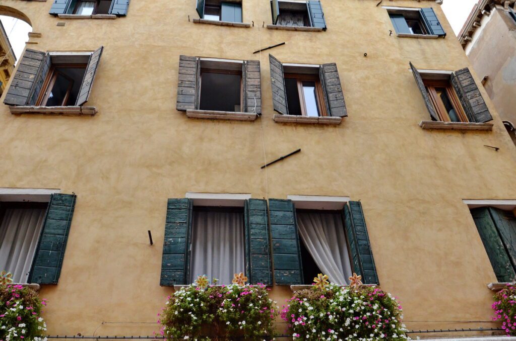 image of shutters and flowers on a home, venice, italy