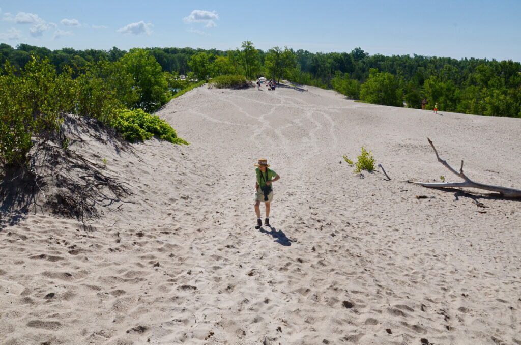 image of jean climbing a sand dune, sandbanks provincial park, ontario