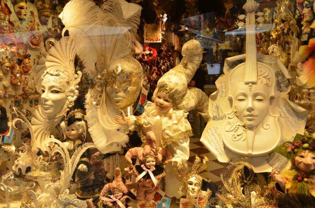 image of venetian masks in a window, venice, italy