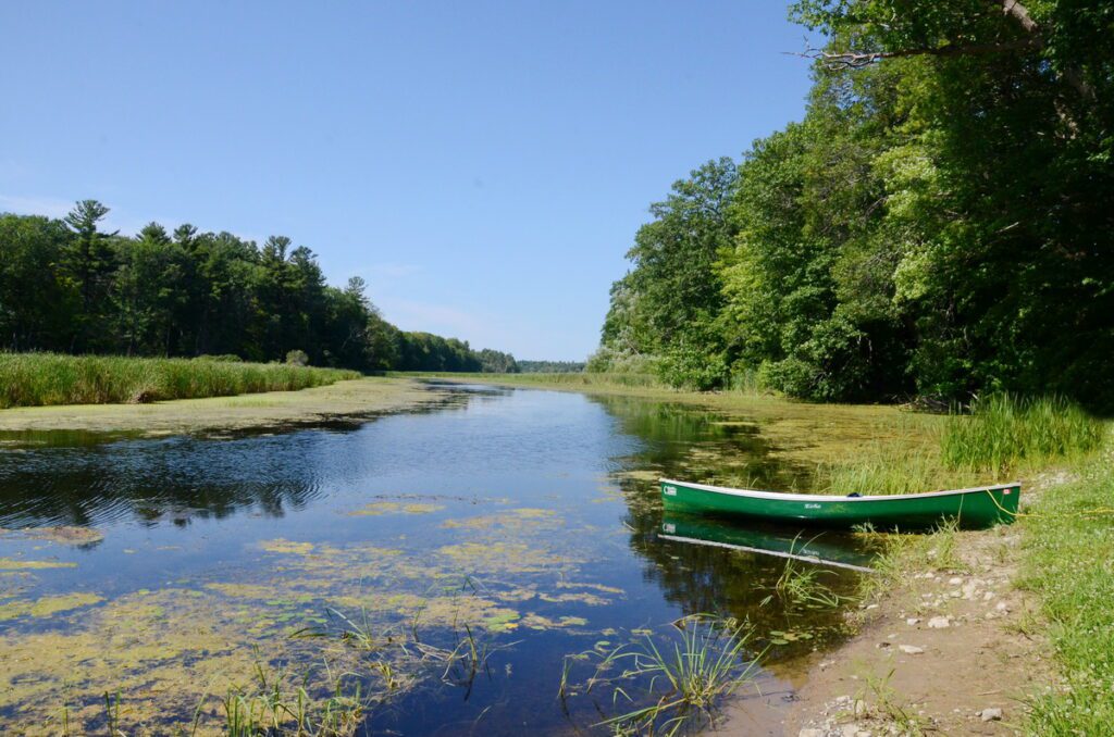 image of a beached canoe, black river, prince edward county, ontario