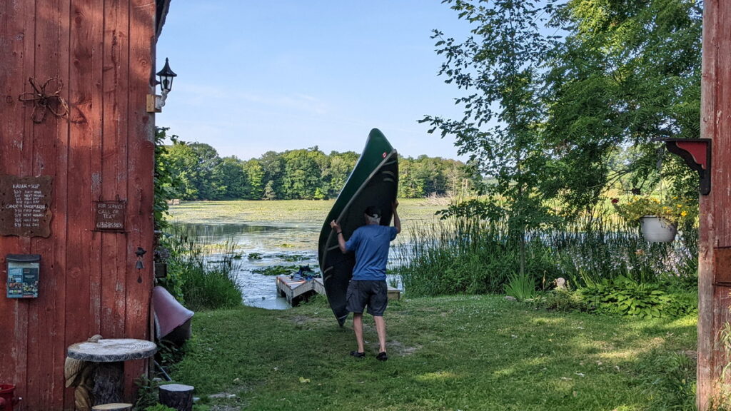 image of bob handling our canoe, black river, prince edward county, ontario