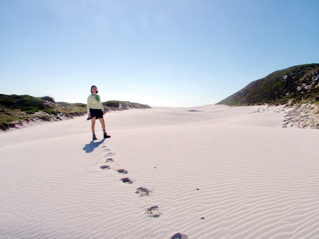image of jean walking the sand dunes, platboom beach, south africa 