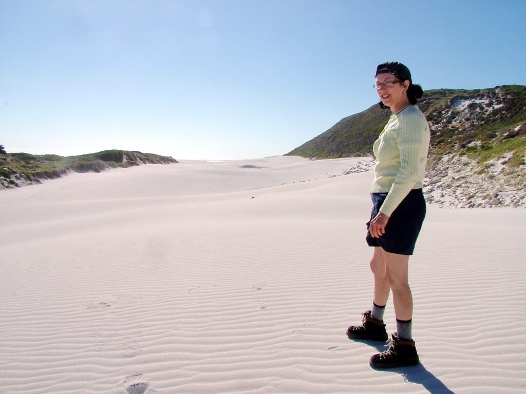 image of jean walking the sand dunes, platboom beach, south africa 