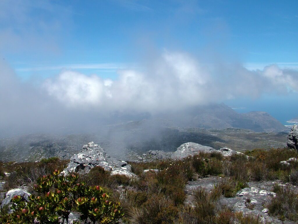 image of table mountain with clouds descending on it, cape town, south africa