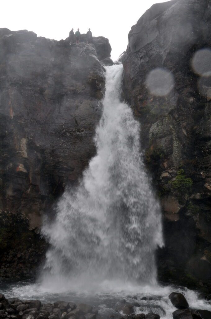 image of people overlooking Taranaki Falls, Mt. Tongariro National Park, New Zealand 