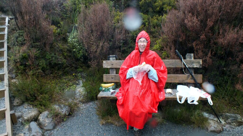 image of jean on a wooden bench, taranaki falls trail, Mt. Tongariro National Park, New Zealand