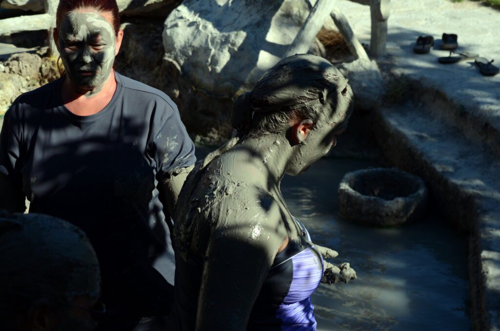 image of 2 people having a mud bath, hornillas volcanic activity centre, costa rica
