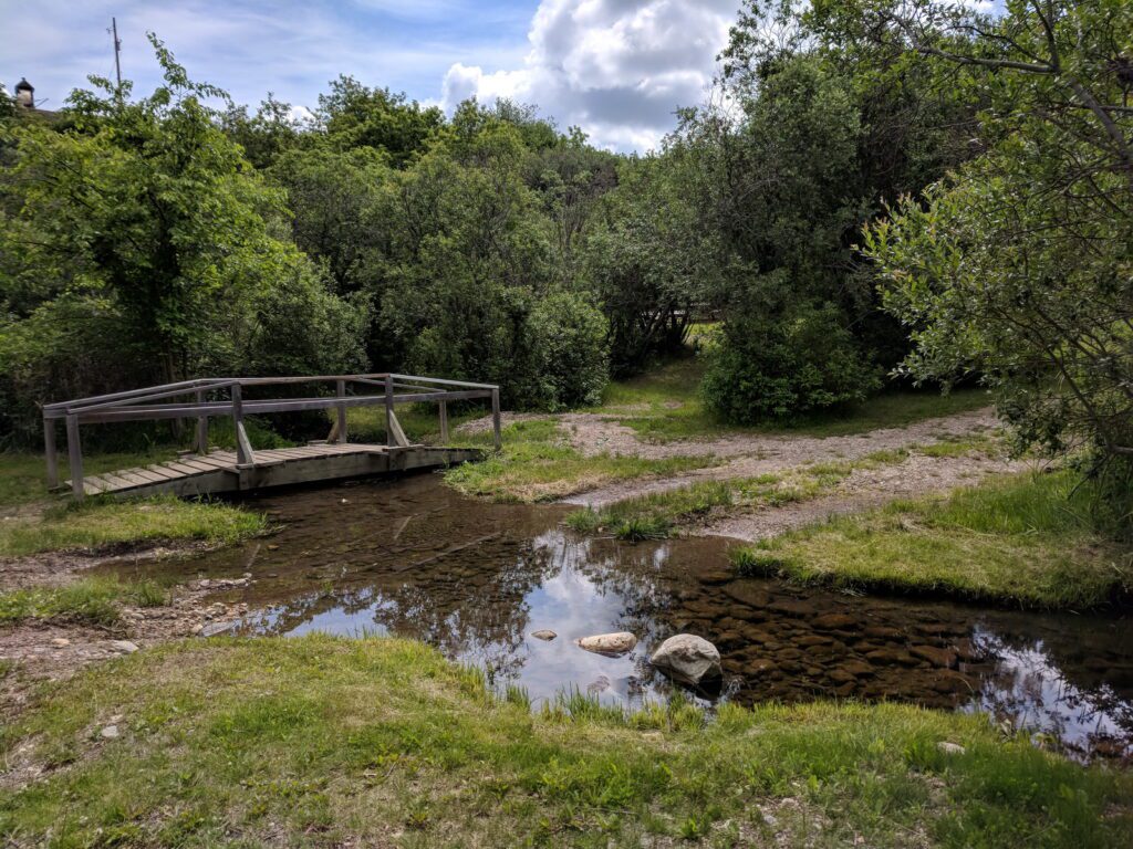 image of a wooden bridge over the stream, wellington park, watrous, saskatchewan 