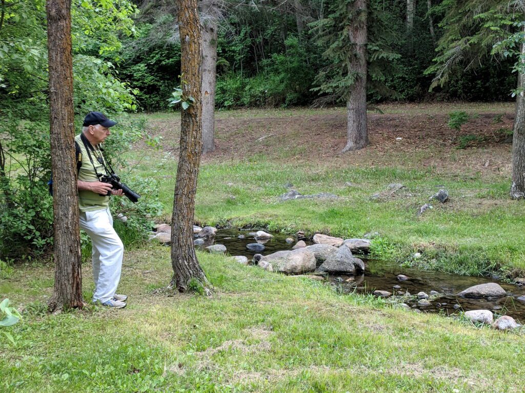 image of bob beside a stream, wellington park, watrous, saskatchewan 