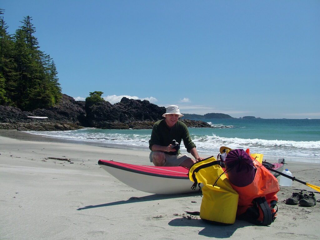 image of bob unpacking his kayak, medallion beach, vargas island, british columbia