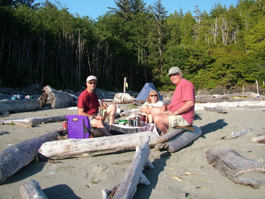 image of bob and others sitting on logs, medallion beach, vargas island, british columbia