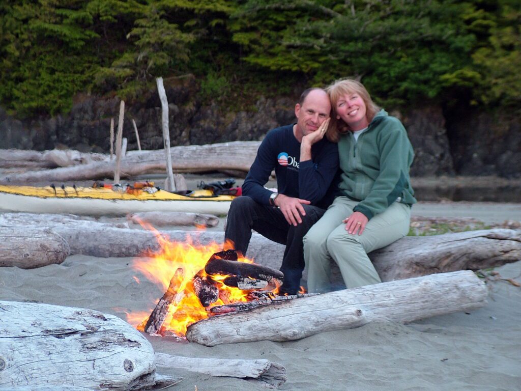 image of claire and martin at a bonfire, medallion beach, vargas island, british columbia