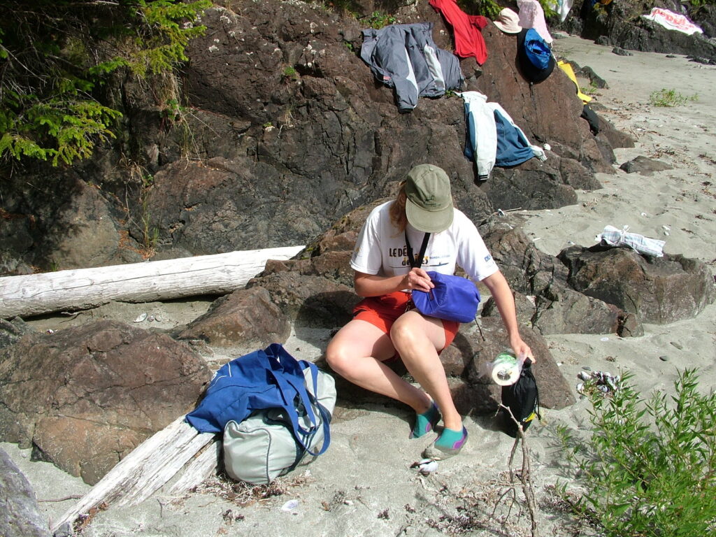 image of person setting up camp, ahous bay, vargas island, british columbia