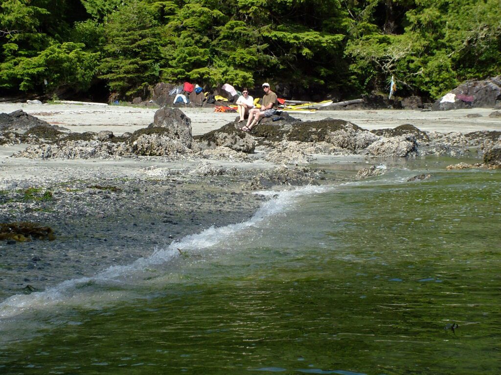 image of people on rocks, ahous bay, vargas island, british columbia