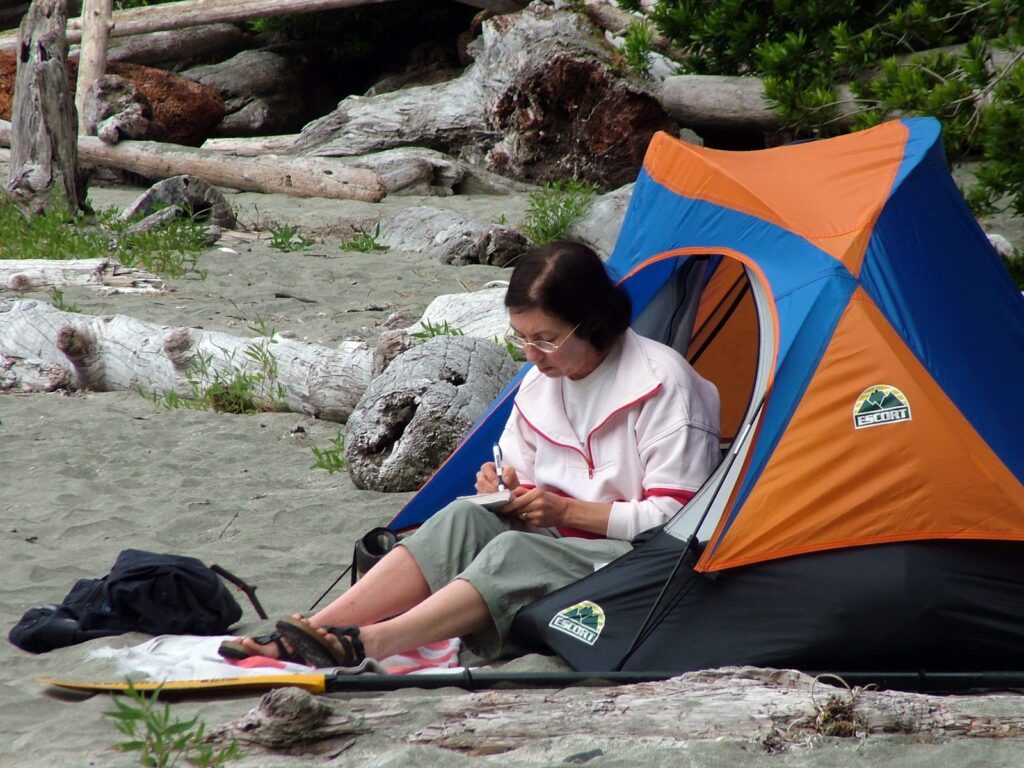 image of jean sitting in the tent, ahous bay, vargas island, british columbia